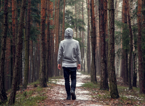 Girl walking away in greenery